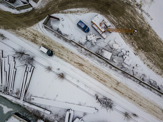 Obraz na płótnie Canvas Snow-covered industrial parking. Aerial drone view. Winter snowy morning.