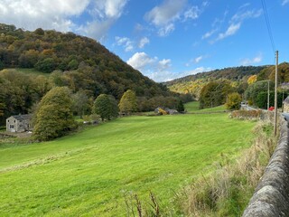 Fototapeta na wymiar View in autumn, of the Midgehole Road, as it follows the valley toward, Hardcastle Crags, Hebden Bridge, UK