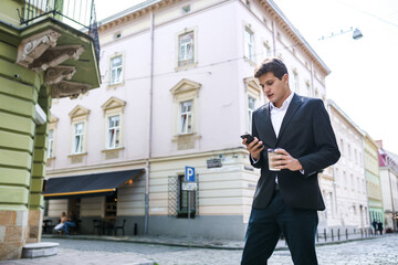 happy man in a suit and shirt smiling talking on the phone on th