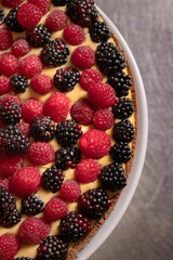 Chef cook preparing tart in his kitchen. Delicious raspberry  tart (tartlet) with whipped cream. Breakfast Buffet Concept, Breakfast Timeю. Various brunch on the table
