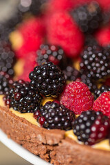 Chef cook preparing tart in his kitchen. Delicious raspberry  tart (tartlet) with whipped cream. Breakfast Buffet Concept, Breakfast Timeю. Various brunch on the table
