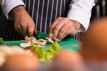 Chef cook preparing vegetables in his kitchen.