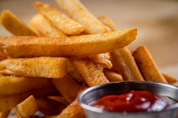 Close up of Golden Orange Yellow Deep French Fries with Ketchup