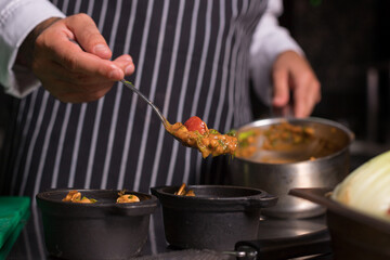 Chef cook preparing eggs  in his kitchen.Early meal with fried eggs served in pan. Breakfast Buffet Concept, Breakfast Timeю. Various brunch on the table