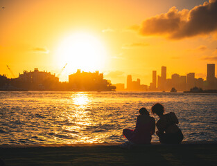 sunset on the beach woman silhouette sky yellow buildings Miami Florida  