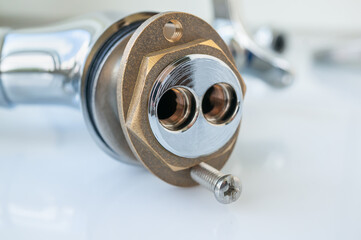 Not installed mixer with one handle kitchen faucet, side view of the base with holes for connecting...