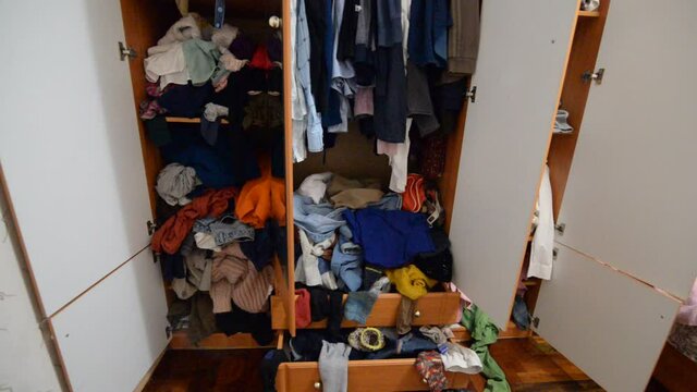 Throwing things into a crowded messy wardrobe. Parsing and sorting things in the wardrobe.