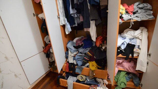 Throwing things into a crowded messy wardrobe. Parsing and sorting things in the wardrobe.