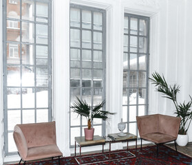 designer apartment interior shelf cabinet with souvenirs bottles figurines bar mirror table chair glass glasses.