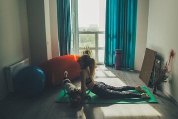Young girl with jack russell dog doign yoga