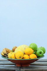 fruit center with melon apples lemons bananas pears on wooden table made with pallets