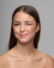 Young beautiful female model close-up studio beauty portrait. Girl with natural make-up and long...