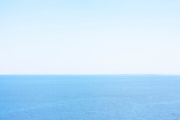 Background made of landscape with blue calm water of sea or ocean and clean sky. Copy space, blank