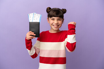 Little caucasian girl isolated on purple background happy in vacation with passport and plane...