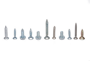 Different screws and bolts on a white background