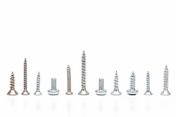 Different screws and bolts on a white background