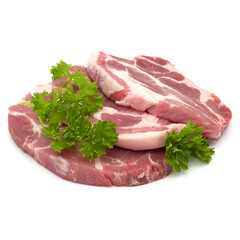Raw pork neck chop meat with parsley herb leaves garnish isolated on white background cutout