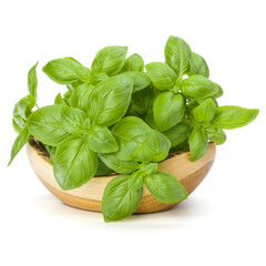 Sweet basil leaves in wooden bowl isolated on white background cutout.