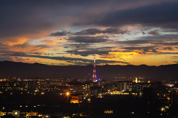 Fototapeta na wymiar TV tower in the Ukrainian city at sunset