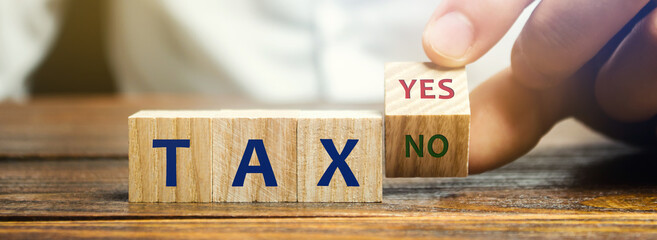 Wooden blocks with the words Tax, yes or no. Taxes payment concept. Tax evasion. Taxation. Business...