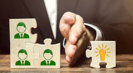 Wooden puzzles with icons of employees and business idea. Concept of new ideas and discoveries. Cooperation teamwork. Achieving goal. Innovation, collective. Achieving task result. Vision