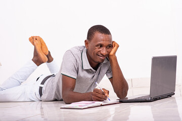 portrait of a handsome student with laptop, smiling.