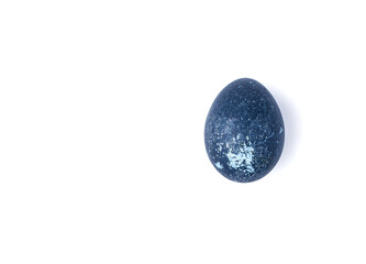 An Easter egg. The chicken egg is colored with natural dyes, isolated on white.