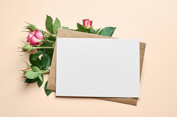 Greeting card with fresh roses flowers frame on paper background