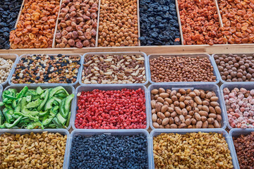 A counter with dried fruits and nuts at the bazaar.