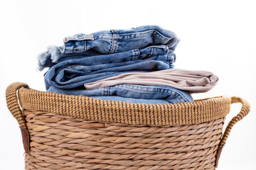 lot of denim pants in a brown basket