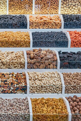 A counter with dried fruits and nuts at the bazaar.