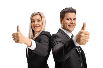 Young businessman and businesswoman showing thumbs up and smiling at camera