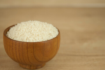Bowl of white rice on wood table