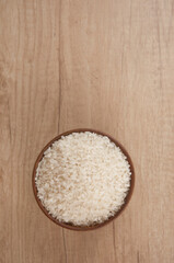 Bowl of white rice on wood table