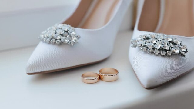 Close-up wedding accessories of the bride, wedding rings, bride's shoes. Morning of the bride. Wedding accessories. Steadicam shots