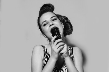 Karaoke. Woman singer at the microphone. Music pinup girl. Pop art retro style.