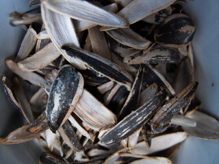 Sunflower seeds peeled and shells in a bowl. Closeup, macro.