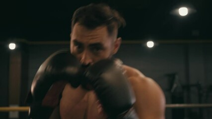 Hispanic shirtless man in boxing gloves working out on boxing ring - Powered by Adobe