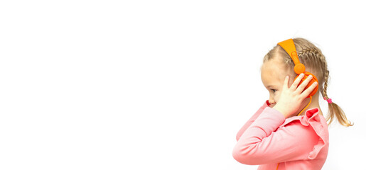 Beautiful five year old girl wearing headphones with copy space banner