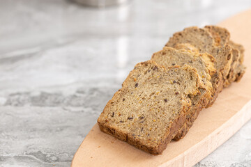 Healthy dark flour toast bread on the wooden board.