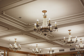 Coffered ceiling with classic crystal chandeliers in the interior. - obrazy, fototapety, plakaty