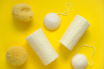  Zero waste concept. Natural organic hygiene products. loofah sponge and spongy konnyaku set   on a bright yellow background.Reasonable consumption concept.Cleanliness and health