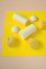  Zero waste concept. Natural organic hygiene products. loofah sponge and spongy konnyaku set   on a  yellow background.Reasonable consumption concept.Cleanliness and health