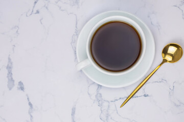 Cup of black coffee on the white marble background