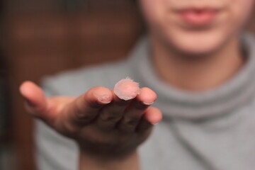 Closeup of a person applying vaseline (petroleum jelly). Concept of slugging - Korean skin care...