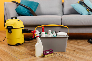 Professional vacuum cleaner and detergents for cleaning sofa.