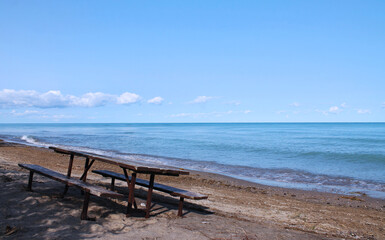 Fototapeta na wymiar Isolated Picnic table on the Beautiful Beach of Huron Lake near Goderich, Ontario, Canada