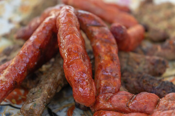 Fototapeta premium Grilled sausage dish on charcoal