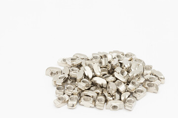 Aluminum nuts for cnc construction. Cnc machine parts above white background.