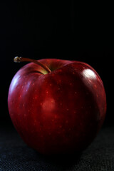 red apple on black background